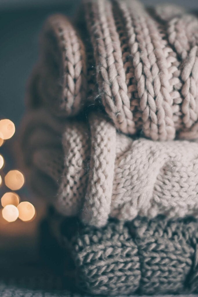 Simple Living Ideas - Simpler Lifestyle with Less Clothes - Photo of a Stack of Gray Sweaters 