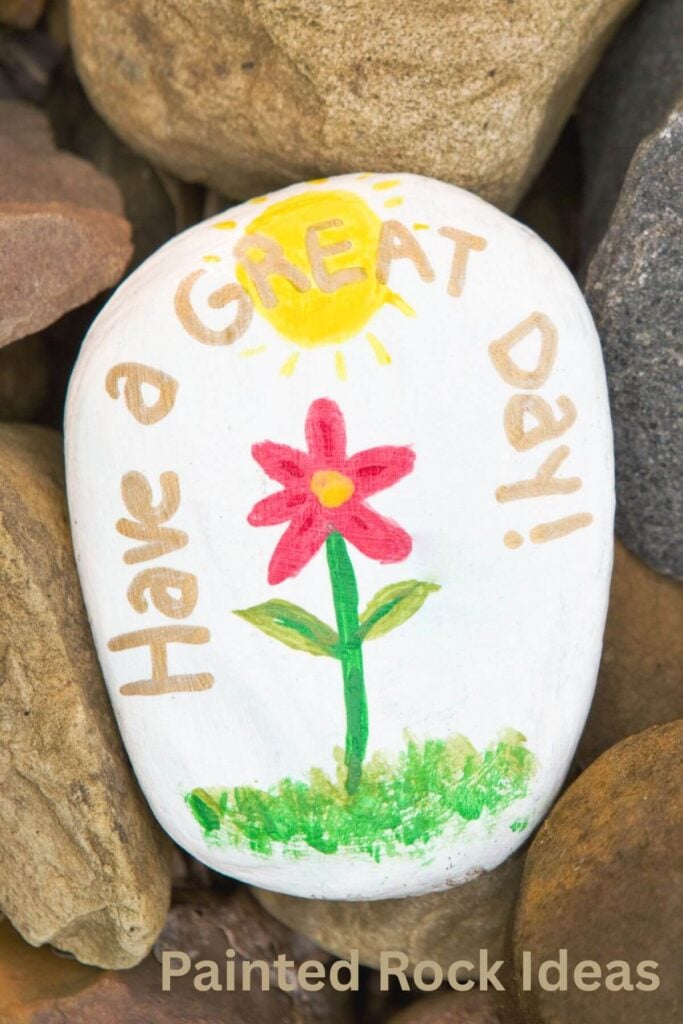 Rock Painting Ideas - Photo of a Kindness Rock with a Flower that says, Have a Great Day!