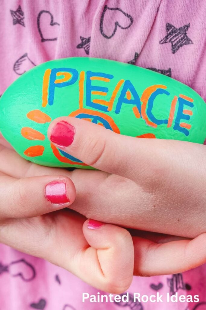 Rock Painting Ideas - Photo of a Painted Rock that says, "Peace"