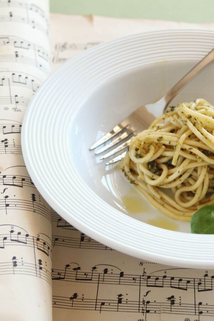 Hygge Family Dinner Traditions - Soft Music Playing - Photo of Spaghetti noodles in a bowl on Top of a Music Book