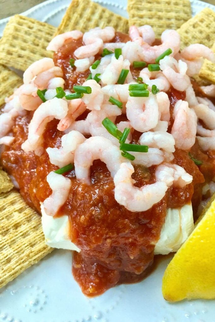 Cream cheese topped with Cocktail Sauce and Cooked Shrimp 