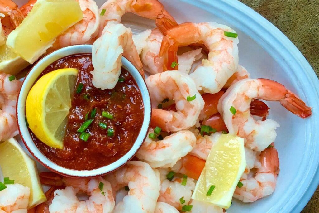 Homemade Cocktail Sauce with Shrimp and Fresh Lemon Wedges 