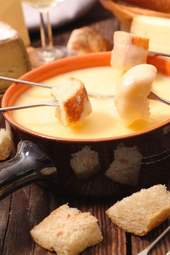 Photo of the Best Cheese Fondue Recipe with Fondue Forks and Bread Cubes 