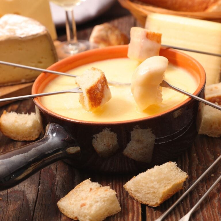 Photo of the Best Cheese Fondue Recipe with Fondue Forks and Bread Cubes