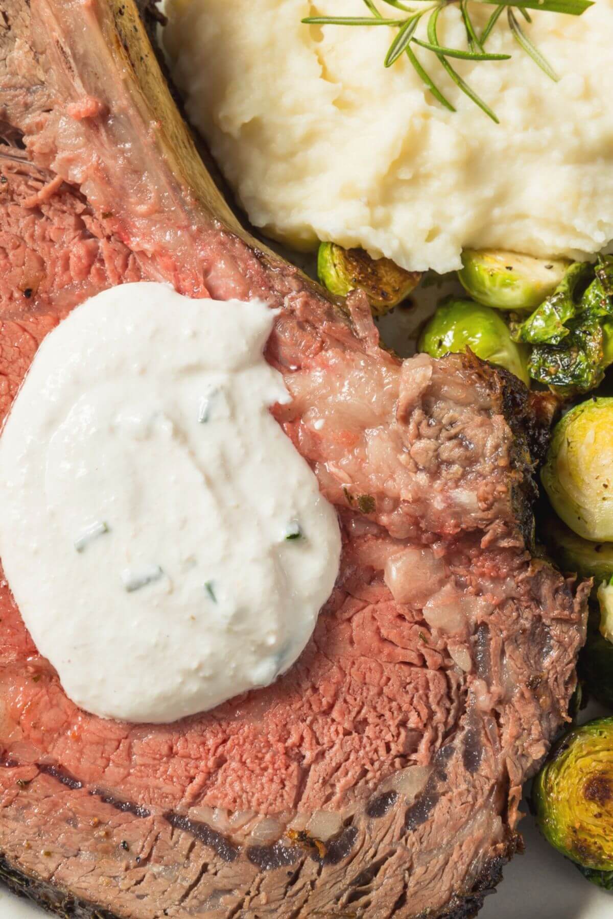 Creamy Horseradish Sauce for Prime Rib. Photo of a Slice of Prime Rib with Creamy Horseradish Sauce and Brussels sprouts 