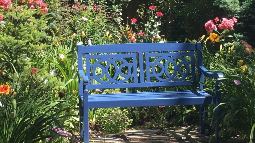 How to Add Hygge to Your Garden - Gardening Bench Surrounded by Flowers