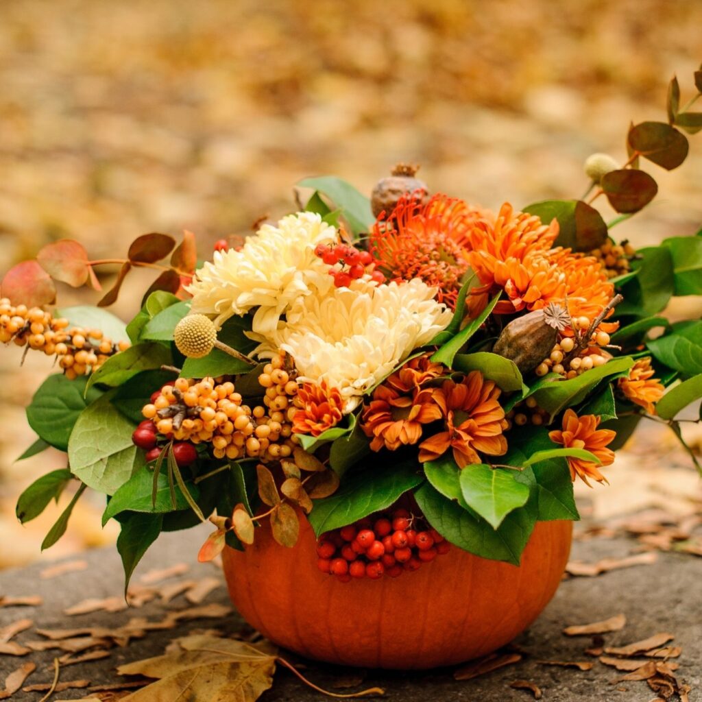 Hollowing out a pumpkin and using it as a vase for flowers.