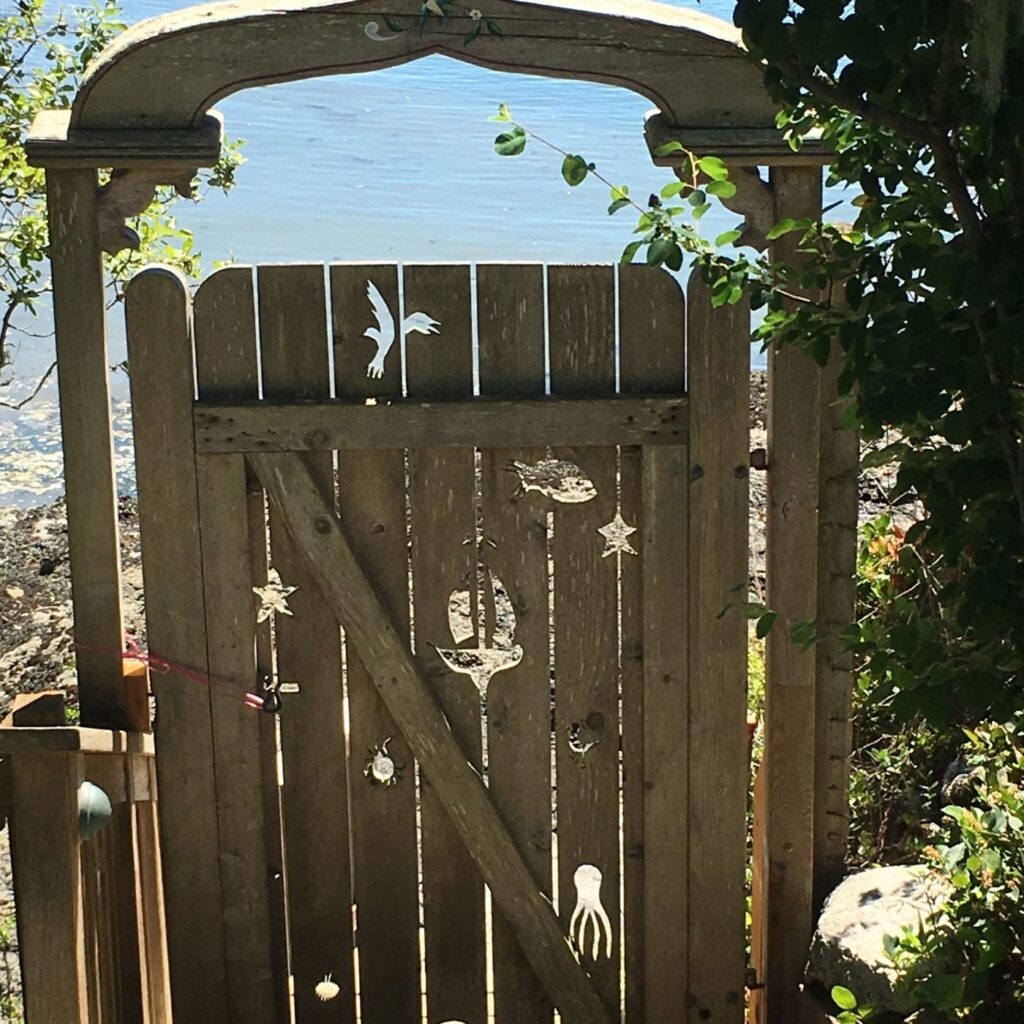 Nautical Garden Gate with cut-outs of sea creatures from the wooden gate. Fun Ideas for Garden Decor