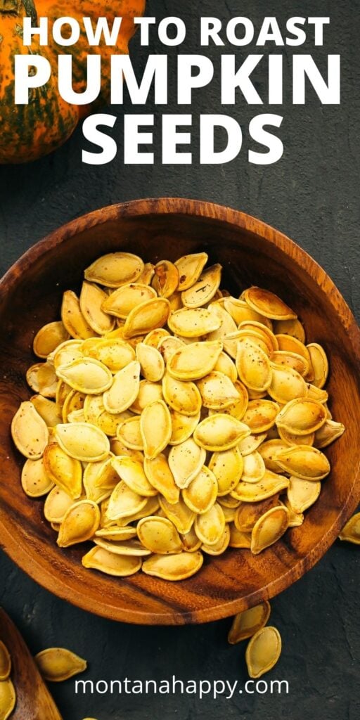 How to Roast Pumpkin Seeds - Pin for Pinterest. Dark gray background with wooden bowl with roasted pumpkin seeds.