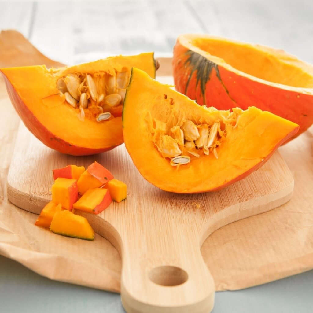 Raw Pumpkin cut up into slices with pumpkin seeds