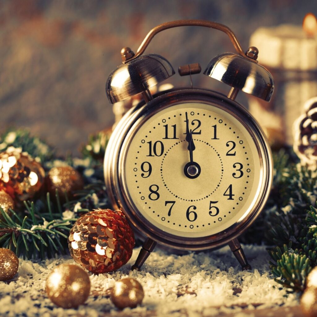 31 Hygge New Year's Resolution Ideas - Vintage Alarm clock with garland and candles
