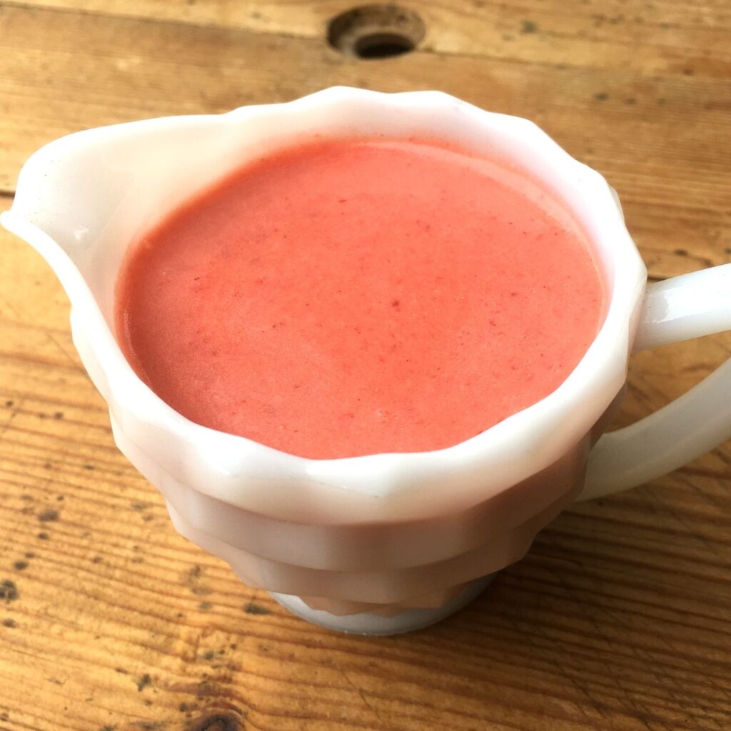 Creamy Strawberry Salad Dressing in a small white pitcher