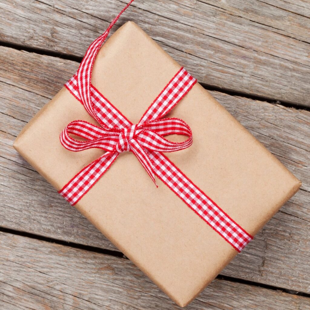 Inexpensive Hostess Gifts They'll Love - Brown wrapped present with checkered ribbon
