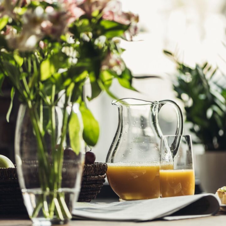 Serene Environment with Pitcher of Orange Juice and Vase with flowers