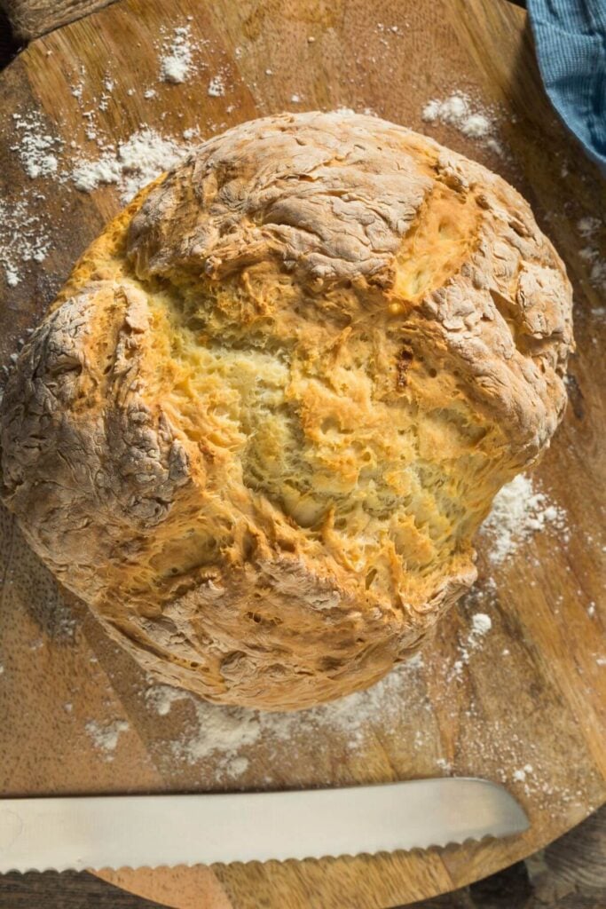 Easy Irish Soda Bread Recipe - Photo of a Loaf of Irish Soda Bread with a Bread Knife 