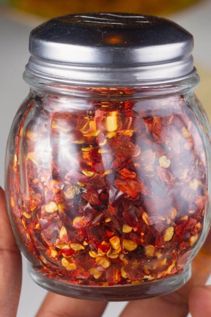 Ultimate List of Pizza Toppings - Photo of a Jar of Red Pepper Flakes 