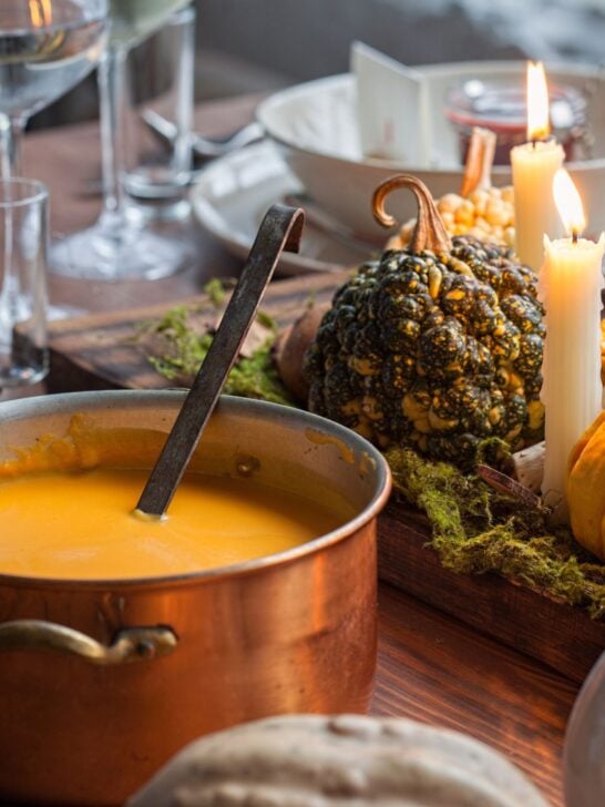 French Country Kitchen with Copper Pots and Pans with Soup and Gourds and Candles 