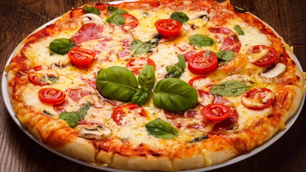 What to do with Basil Leaves - Photo of a Pizza with Mushrooms, Tomatoes, and Basil