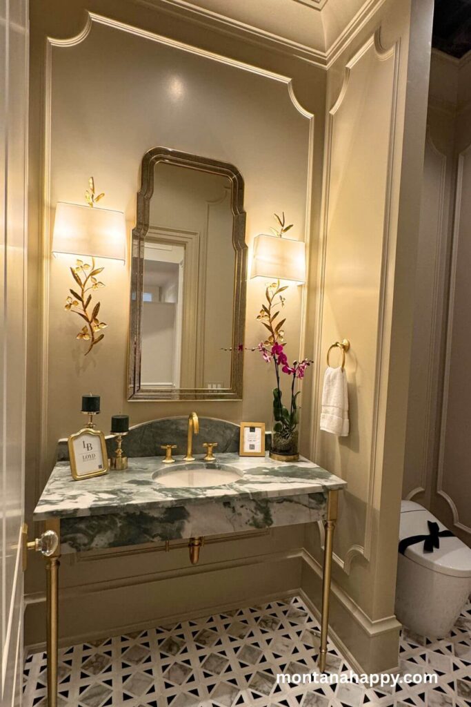 Modern Home Decor Ideas - Elegant Bathroom with Brass Sconces and Marble Sink -A modern bathroom feels luxuriously fresh with its green and white marble sink framed by elegant brass accents. Brass floral sconces add a soft, artistic glow that completes the sophisticated, polished look.