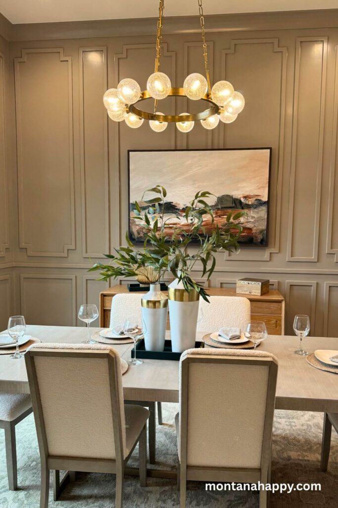 Modern Home Decor Ideas - Modern Dining Room Inspiration - A neutral cream and tan dining room feels airy and elegant with its board-and-batten walls, while a light modern wood buffet adds warmth beneath a simple, calming painting.