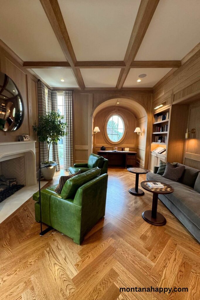 Modern Home Decor Ideas - Modern Living Room Designs -This modern sitting area features deep green leather chairs positioned in front of a sleek fireplace. An alcove with a desk offers a quiet workspace, while a plush gray velvet couch anchors the room, paired with two elegant chess tables that add a touch of intellectual charm.