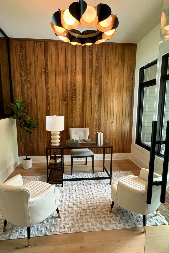 Modern Home Decor Ideas Photo of Modern Home Decor with Wood Paneling - This modern home office adds warmth with its rich wood paneling, which adds texture and depth to the space. In front of the streamlined desk, two modern white chairs provide a clean, minimalist contrast, creating a balanced and inviting work environment.
