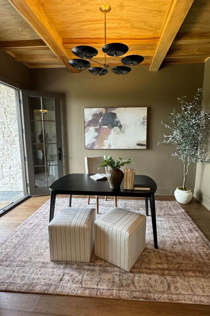 Modern Home Decor Ideas - Photo of Modern Office Ideas with Black Desk - This modern office exudes sleek sophistication with a striking black wood desk as the focal point. Two contemporary ottomans sit neatly in front, adding both style and function.