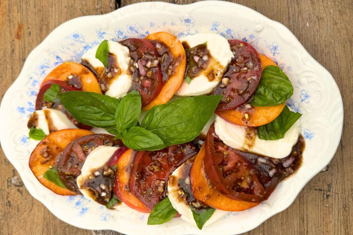 Photo of Easy Peach Caprese Salad for Grilled Chicken on an Oval Dish